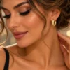 Γυναίκα που φορά χρυσό στρογγυλό σκουλαρίκι κρίκο